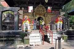 10 Kathmandu Valley Sankhu Vajrayogini Temple Entrance With Two White Snow Lions, Bells and Torana Door